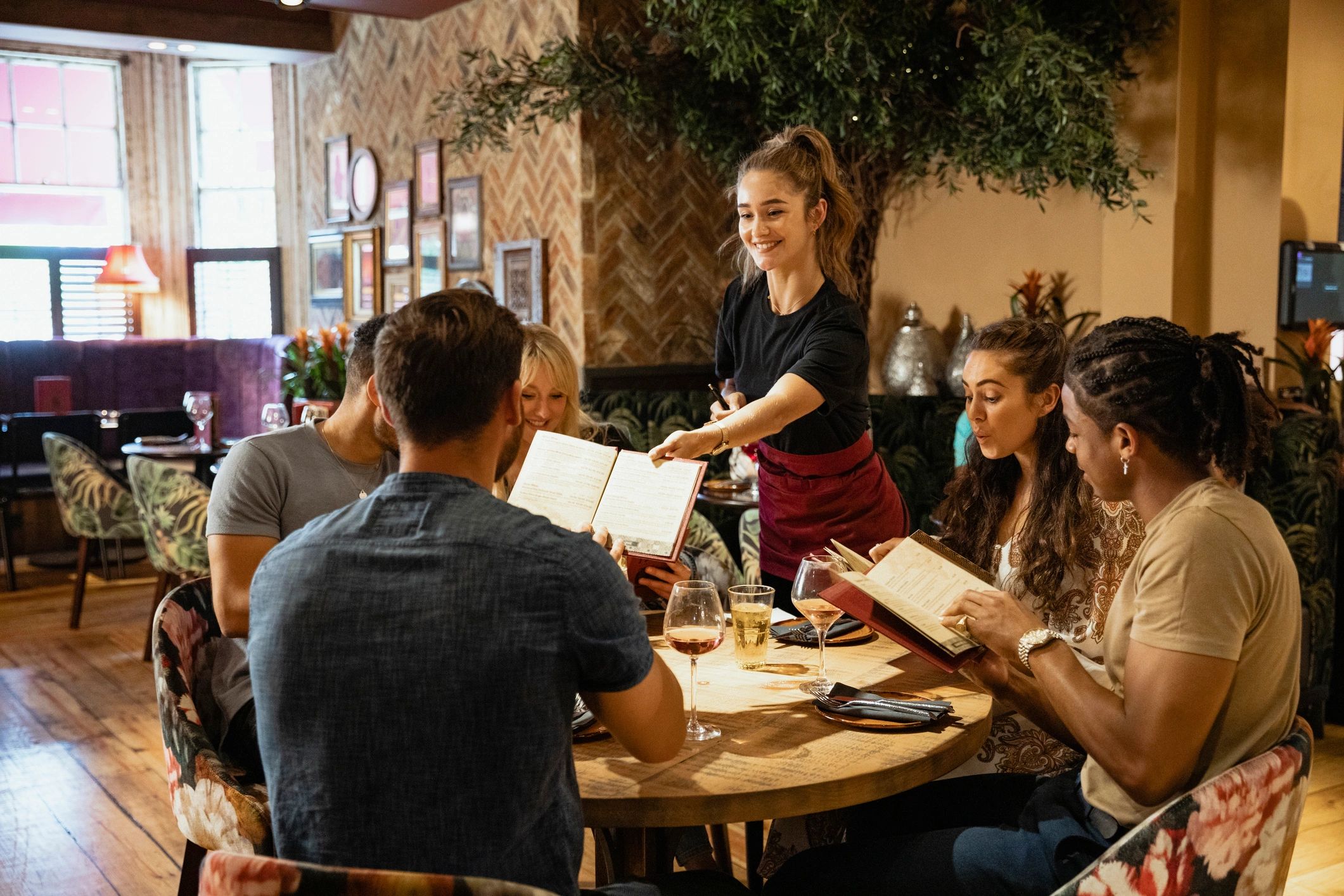 Guests reviewing menus at an elegant catered event